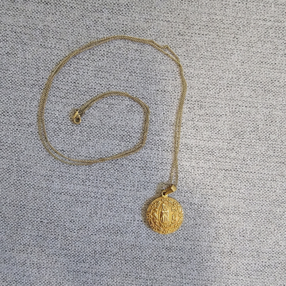Plated gold costume necklace featuring Vigin Mary pendant